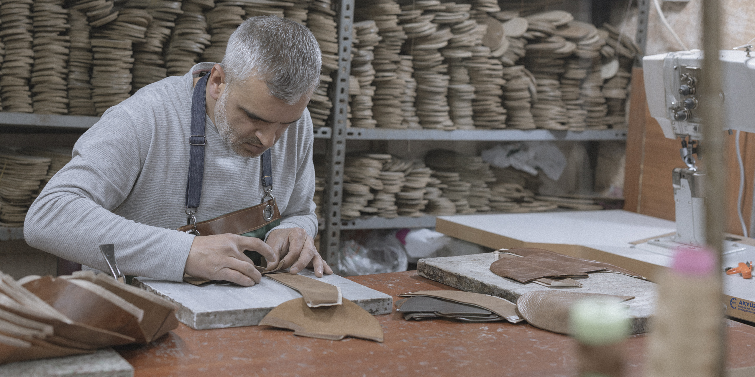 Hand-cut leather panels and stacked insoles
