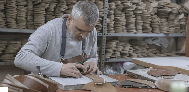 Hand-cut leather panels and stacked insoles